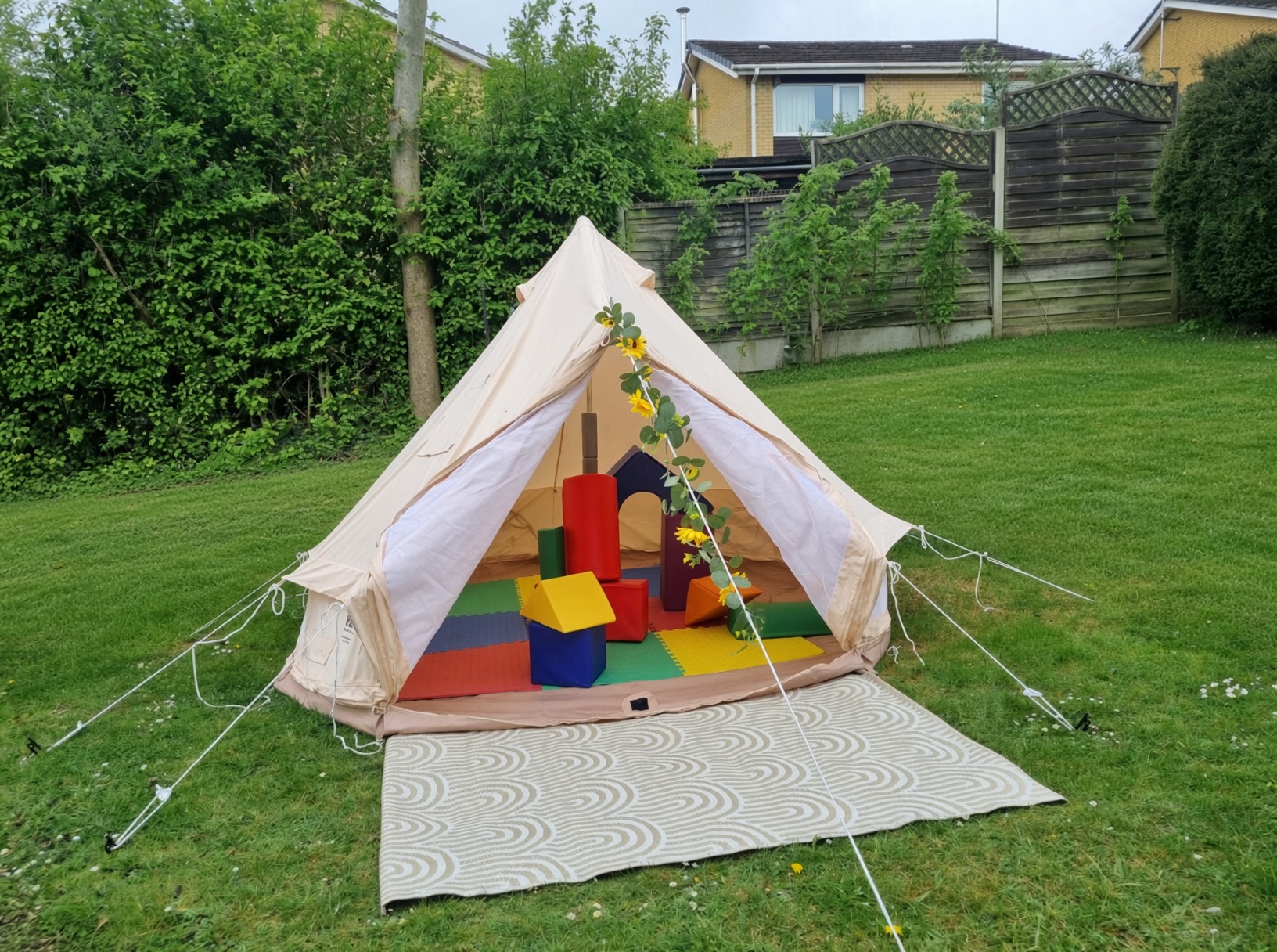 Soft play foam shapes inside a bell tent for a kids garden party